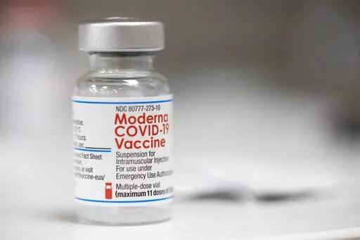 A vial of the Moderna COVID-19 vaccine is displayed on a counter at a pharmacy in Portland, Ore. on Dec. 27, 2021. A government advisory panel met Tuesday, June 14, 2022,  to decide whether to recommend a second brand of COVID-19 vaccine for school-age children and teens. The Food and Drug Administration's outside experts will vote on whether Moderna's vaccine is safe and effective enough to give kids ages 6 to 17.  If the panel endorses the shot and the FDA agrees, it would become the second op