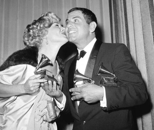 Ross Bagdasrian gets a kiss from singer Helen Greco as she handed him the third of three Grammys he won on May 4, 1959 in Los Angeles. He won Grammys for Best Recording for Children, Best Comedy Performance, and Best Non-Classical Engineered Song. (AP Photo/Don Brinn, File)