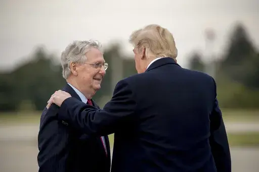 President Donald Trump speaks with Senate Majority Leader Mitch McConnell of Ky., left, as he arrives at Blue Grass Airport in Lexington, Ky., Oct. 13, 2018, to travel to Richmond, Ky., for a rally. (AP Photo/Andrew Harnik, File)