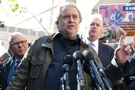 Steve Bannon, center, a longtime ally of former President Donald Trump and convicted of contempt of Congress,  accompanied by his attorneys David Schoen, left, and Evan Corcoran, right, speaks to the media as he leaves the federal courthouse on Friday, Oct. 21, 2022, in Washington. Bannon was sentenced to 4 months behind bars for defying a Jan. 6 committee subpoena. ( AP Photo/Jose Luis Magana)