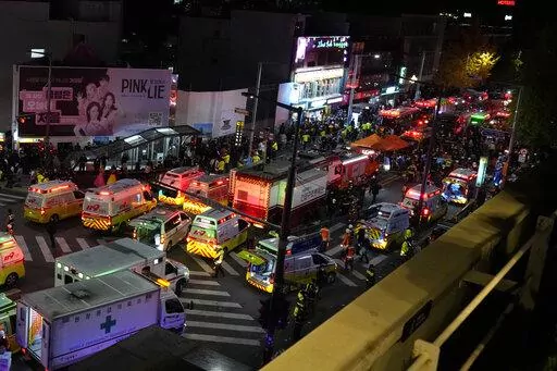 Ambulances and rescue workers arrive at the street near the scene of a crowd surge in Seoul, South Korea, Oct. 30, 2022. The Halloween party crush in Seoul has caused an outpouring of public sympathy toward the 150 dead, but there's also a strong level of embarrassment and anger from citizens toward the country that they say still ignores safety and regulatory issues. (AP Photo/Lee Jin-man, File)