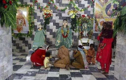 People from Pakistani Hindu community attend a religious ceremony at the Sadhu Bela temple, located in an island on the Indus River, in Sukkur, Pakistan, Wednesday, Oct. 26, 2022. On the banks of the Indus River, which flows through Pakistan and into its southern Sindh province, Hindus wait for brightly colored boats to ferry them to an island that has housed Sadhu Bela temple for almost 200 years. The island was gifted to the Hindu community by wealthy Muslim landlords in Sindh, an unthinkable 