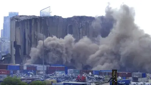 This frame grab from video shows dust rising from silos in the port of Beirut, Lebanon, Sunday, July 31, 2022. A section of Beirut's massive port grain silos, shredded in the 2020 explosion, collapsed on Sunday after a weekslong fire triggered by grains that had fermented and ignited in the summer heat. (AP Photo)