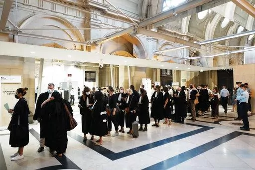 Lawyers and participants arrive at the special courtroom Wednesday, Sept. 8, 2021 in Paris. French prosecutors on Friday laid out their demands for sentences in the historic Paris trial of 20 men suspected of critical roles in France's worst peacetime attack, the Islamic State massacres that killed 130 people in 2015. For Salah Abdeslam, the only surviving member of that night's attacking jihadis, prosecutors demanded a life sentence. (AP Photo/Thibault Camus, file)