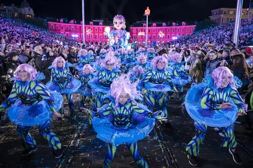 Performers dance during a parade through Place Massena during the opening ceremony of the 152nd edition of the Nice Carnival in Nice, southern France, Saturday, Feb. 15, 2025. (AP Photo/Lewis Joly)
