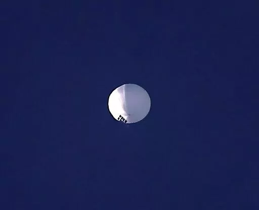ADDS PENTAGON RESPONSE THAT IT WOULD NOT CONFIRM - A high altitude balloon floats over Billings, Mont., on Wednesday, Feb. 1, 2023. The U.S. is tracking a suspected Chinese surveillance balloon that has been spotted over U.S. airspace for a couple days, but the Pentagon decided not to shoot it down due to risks of harm for people on the ground, officials said Thursday, Feb. 2, 2023. The Pentagon would not confirm that the balloon in the photo was the surveillance balloon. (Larry Mayer/The Billin