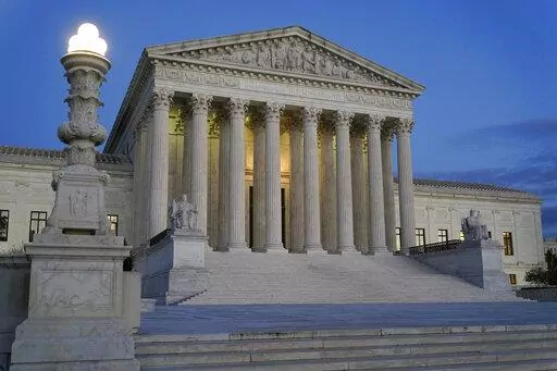 Light illuminates part of the Supreme Court building at dusk on Capitol Hill in Washington, Nov. 16, 2022. The Supreme Court has agreed to hear an appeal arising from a murder-for-hire ordered by the onetime leader of a violent international crime ring. The justices said Tuesday they will review the case of Adam Samia, who is serving a life sentence for killing a real estate broker in the Philippines. (AP Photo/Patrick Semansky, File)