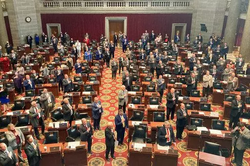 Members of the Missouri House of Representatives recite the Pledge of Allegiance as they begin their annual legislative session, Jan. 5, 2022, in Jefferson City, Mo. Women who serve in the Missouri House will face a tougher dress code when they return to the floor this week after a debate that Democrats panned as a pointless distraction from the issues facing the state. The new rules require female legislators and staff members to wear a jacket such as a cardigan or blazer. The Republican lawmak
