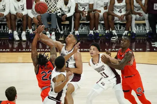 Mississippi State forward Garrison Brooks (10) attempts to block a layup attempt by Auburn guard Allen Flanigan (22) during the first half of an NCAA college basketball game in Starkville, Miss., Wednesday, March. 2, 2022. (AP Photo/Rogelio V. Solis)