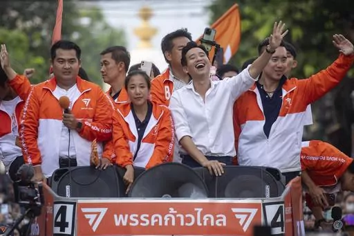 Pita Limjaroenrat, center, (white shirt) leader of Move Forward Party, waves to his supporters, in Bangkok, Monday, May 15, 2023. Fresh off a stunning election victory in which they together captured a majority of seats in the House of Representatives, Thailand's top two opposition parties began planning Monday for the next stage in their bid to replace the military-dominated government. (AP Photo/Wason Wanichakorn)