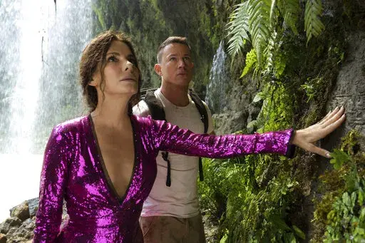 This image released by Paramount Pictures shows Sandra Bullock, left, and Channing Tatum in a scene from "The Lost City."  (Kimberley French/Paramount Pictures via AP)
