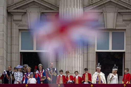Britain's King Charles III and Queen Camilla wave to the crowds from the balcony of Buckingham Palace after the coronation ceremony in London, Saturday, May 6, 2023. King Charles III’s decision to be open about his cancer diagnosis has helped the new monarch connect with the people of Britain and strengthened the monarchy in the year since his dazzling coronation at Westminster Abbey. (AP Photo/ Andreea Alexandru, File)