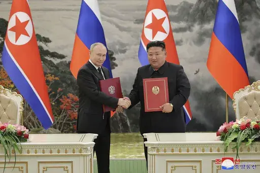 In this photo provided by the North Korean government, North Korean leader Kim Jong Un, right, and Russia's President Vladimir Putin shake hands after signing a comprehensive strategic partnership in Pyongyang, North Korea Wednesday, June 19, 2024. The content of this image is as provided and cannot be independently verified. Korean language watermark on image as provided by source reads: "KCNA" which is the abbreviation for Korean Central News Agency. (Korean Central News Agency/Korea News Serv
