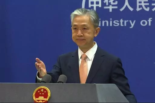Chinese Foreign Ministry spokesperson Wang Wenbin reacts during the daily presser at the Ministry of Foreign Affiairs in Beijing, on May 27, 2022. China denied all accusations of an overseas police presence, saying the United States was making “groundless accusations” after U.S. law enforcement arrested two men in New York for establishing a secret police station. (AP Photo/Liu Zheng, File)