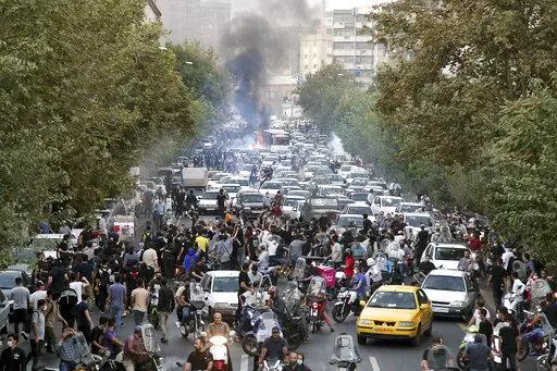 In this photo taken by an individual not employed by the Associated Press and obtained by the AP outside Iran, protesters chant slogans during a protest over the death of a woman who was detained by the morality police, in downtown Tehran, Iran, Sept. 21, 2022. (AP Photo, File)