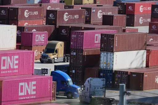 Containers are stacked at the Port of Los Angeles Wednesday, April 2, 2025, in Los Angeles. (AP Photo/Damian Dovarganes)