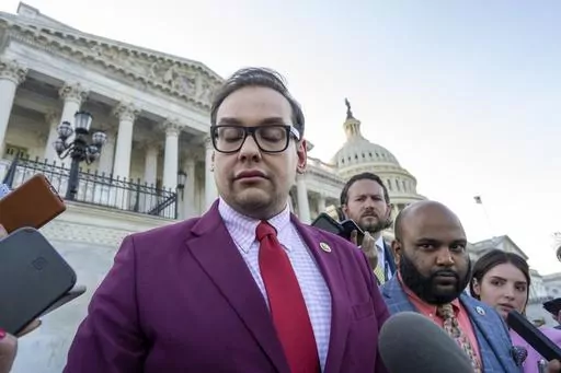 Rep. George Santos, R-N.Y., speaks to reporters outside the Capitol, as his top political aide Vish Burra, second from right, listens, after an effort to expel Santos from the House, in Washington, Wednesday, May 17, 2023. A man who briefly worked as an aide to Santos told House investigators Wednesday, May 31, that he got his job after sending a series of payments to Burra, Santos' director of operations. (AP Photo/J. Scott Applewhite, File)