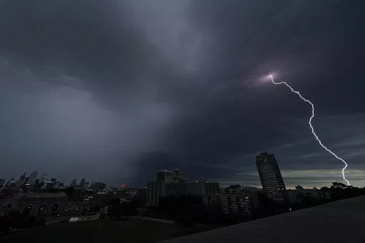 Lightning strikes in the distance as a thunderstorm passes over downtown Kansas City, Mo., July 30, 2023. Tens of millions of Americans stretching from Lincoln, Neb., to Baltimore could face strong thunderstorms Monday night, April 15, 2024, through Wednesday, April 17, with tornadoes possible in some states. (AP Photo/Charlie Riedel, File)