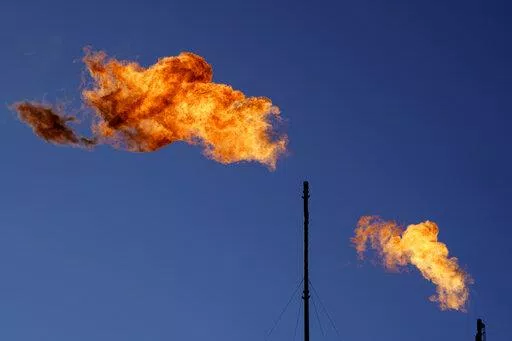 Flares burn off methane and other hydrocarbons at an oil and gas facility in Lenorah, Texas, Oct. 15, 2021. The U.N. Environment Programme said Friday, Nov. 11, that the new Methane Alert and Response System — MARS for short — is intended to help companies act on major emissions sources but also provide data in a transparent and independent way. (AP Photo/David Goldman, File)