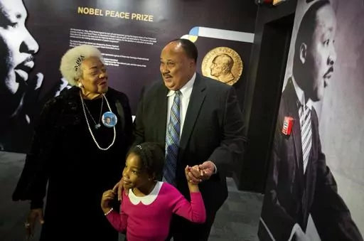 Martin Luther King III, right, the son of Rev. Martin Luther King Jr., walks with his daughter Yolanda, and Naomi King, left, the wife of Rev. King's brother, A.D., through an exhibition devoted to the awarding of the Nobel Peace Prize to King at the Martin Luther King Jr. Historical Site, Wednesday, Dec. 10, 2014, in Atlanta. Civil rights activist Naomi Barber King died Thursday, March 7, 2024, in Atlanta, according to family members. She was 92. (AP Photo/David Goldman, File)