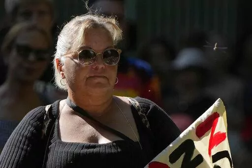 A dragonfly buzzes past a woman attending an Invasion Day rally in Sydney, Thursday, Jan. 26, 2023. Australia is marking the anniversary of British colonists settling modern day Sydney in 1788 while Indigenous protesters deride Australia Day as Invasion Day. (AP Photo/Rick Rycroft)