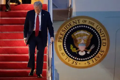 President Donald Trump walks down the stairs of Air Force One upon his arrival at Joint Base Andrews, Md., Sunday, March 30, 2025. (AP Photo/Luis M. Alvarez)