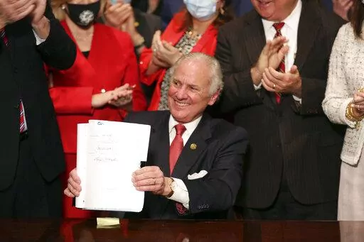 South Carolina Gov. Henry McMaster holds up a bill banning almost all abortions in the state after he signed it into law on Feb. 18, 2021, in Columbia, S.C. The South Carolina ban on abortions after cardiac activity is no more after the latest legal challenge to the state’s 2021 law proved successful. The state Supreme Court ruled Thursday, Jan. 5, 2023, that the restrictions violate the state constitution’s right to privacy. (AP Photo/Jeffrey Collins, File)