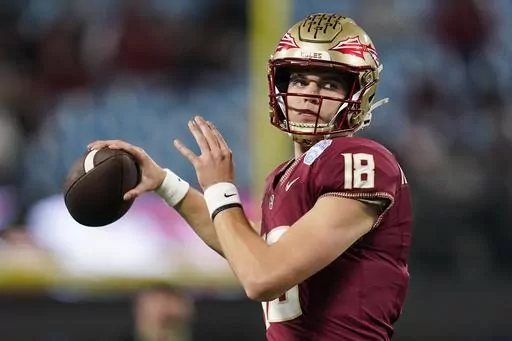 Florida State quarterback Tate Rodemaker warms up for the team' Atlantic Coast Conference championship NCAA college football game against Louisville, Saturday, Dec. 2, 2023, in Charlotte, N.C. Could the fourth-ranked Seminoles, with a victory against defending national champion and No. 6 Georgia in the Orange Bowl be voted No. 1 in the final Associated Press college football poll? While voters say they would be open-minded to it, the current state of college football’s postseason all but rende
