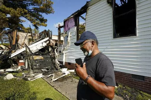 Elder Lloyd Caston, 73, walks around the remains Epiphany Lutheran Church near mid-town Jackson, Miss., Tuesday, Nov. 8, 2022. Authorities in Mississippi's capital city are on the hunt for a suspected arsonist who set several fires early Tuesday morning on and near the campus of Jackson State University, a historically Black public university. At least two of the buildings set ablaze were churches. (AP Photo/Rogelio V. Solis)