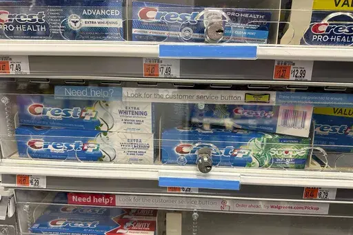 Tubes of toothpaste are displayed behind a locked, plastic barrier to prevent shoplifters from stealing the products at a store in the Manhattan borough of New York on January 31, 2024. (AP Photo/Ted Shaffrey)