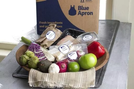 This Oct. 6, 2014, file photo shows an example of a home-delivered meal from Blue Apron. Meal kit subscriptions shot up in popularity in 2020, but many customers don’t stay past the initial promotional period. Though a full-price subscription may be more expensive than going to the grocery store, the variety of recipes, convenience of delivery and enticing promotional prices may make a subscription worth the cost, even just temporarily. ( AP Photo/Matthew Mead, File)