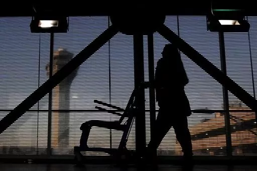 An airline employee transfers a wheelchair to her station at O'Hare International Airport in Chicago, Nov. 23, 2022. The Biden administration will propose Thursday, Feb. 29, 2024, to make it easier for the government to fine airlines for damaging or misplacing wheelchairs by making it an automatic violation of a federal law on accessible air travel. (AP Photo/Nam Y. Huh, File)