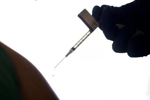 A droplet falls from a syringe after a health care worker was injected with the Pfizer-BioNTech COVID-19 vaccine at Women & Infants Hospital in Providence, R.I., on Dec. 15, 2020. On Friday, June 10, 2022, The Associated Press reported on stories circulating online incorrectly claiming that 20,000 people have died from COVID-19 vaccines. The figure misrepresents data maintained by the Centers for Disease Control and Prevention and the Food and Drug Administration. To date, a total of nine deaths
