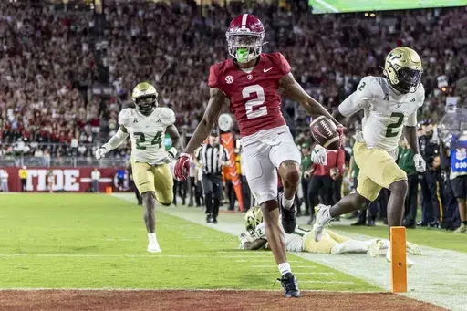 Alabama wide receiver Ryan Williams (2) scores a touchdown on a 43-yard pass reception against South Florida during the second half of an NCAA college football game, Saturday, Sept. 7, 2024, in Tuscaloosa, Ala. South Florida linebacker Mac Harris (24) and defensive back Tavin Ward (2) trail the play. (AP Photo/Vasha Hunt)