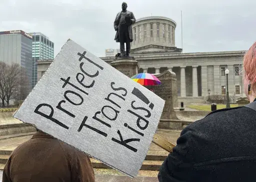 Protesters advocating for transgender rights and healthcare stand outside of the Ohio Statehouse on Wednesday, Jan. 24, 2024, in Columbus, Ohio. (AP Photo/Patrick Orsagos, File)