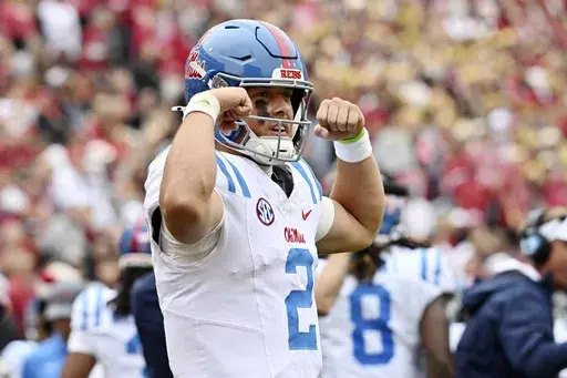 Mississippi quarterback Jaxson Dart (2) celebrates after throwing a 62-yard touchdown pass against Arkansas during the first half of an NCAA college football game Saturday, Nov. 2, 2024, in Fayetteville, Ark. (AP Photo/Michael Woods)