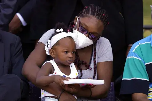 Starmanie Jackson holds her child, Gabriella, during a news conference Tuesday, July 12, 2022, in Detroit. At the time of her incarceration in April 2019, Jackson, an impoverished single mother of 2- and 4-year-old children, had her bail set at $700 over outstanding traffic tickets and a charge alleging domestic violence. Because she could not afford to pay, Jackson, who had never been arrested before, was separated from her children for the first time in their lives. Michigan's largest district