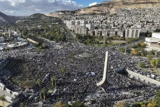 Syrians gather during a celebratory demonstration following the first Friday prayers since Bashar Assad's ouster, in Damascus' central square, Syria, Friday, Dec. 13, 2024. (AP Photo/Ghaith Alsayed)