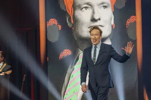 Comedian Conan O'Brien walks out on stage at the start of the 25th Annual Mark Twain Prize for American Humor Celebrating Conan O'Brien, Sunday, March 23, 2025, at the Kennedy Center for the Performing Arts in Washington. (AP Photo/Kevin Wolf)