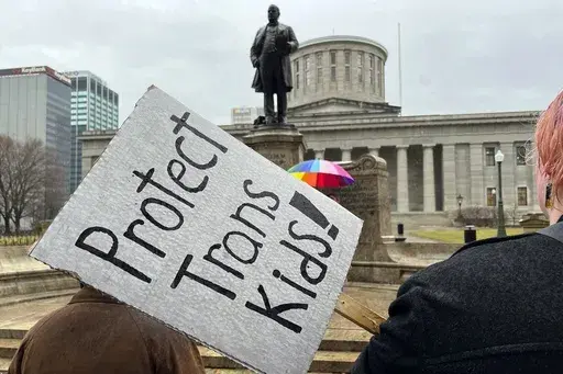 Demonstrators advocating for transgender rights and healthcare stand outside of the Ohio Statehouse on Jan. 24, 2024, in Columbus, Ohio. In a preliminary injunction granted Thursday, U.S. District Judge Terry A. Doughty called the new rule an "abuse of power" and a "threat to democracy." His order blocks the rule in Louisiana, which filed a challenge to the rule in April, and in Mississippi, Montana and Idaho, which joined the suit. (AP Photo/Patrick Orsagos, File)