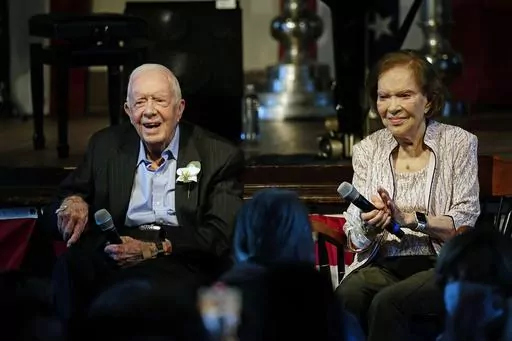 Former U.S. President Jimmy Carter and his wife, former first lady Rosalynn Carter, sit together during a reception to celebrate their 75th wedding anniversary, July 10, 2021, in Plains, Ga. Rosalynn Carter, the closest adviser to Jimmy Carter during his one term as U.S. president and their four decades thereafter as global humanitarians, died Sunday, Nov. 19, 2023. She was 96. (AP Photo/John Bazemore, Pool, File)