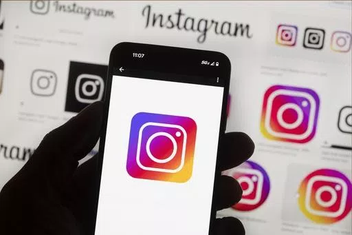 The Instagram logo is seen on a cell phone in Boston, USA, Oct. 14, 2022. Instagram says it’s testing out new tools to protect young people and combat sexual extortion, including a feature that will automatically blur nudity in direct messages. The social media platform said in a blog post on Thursday, April 11, 2024 that the new features are part of its work to fight sexual scams and other forms of “image abuse” and to make it tougher for criminals to contact teens. (AP Photo/Michael Dwye