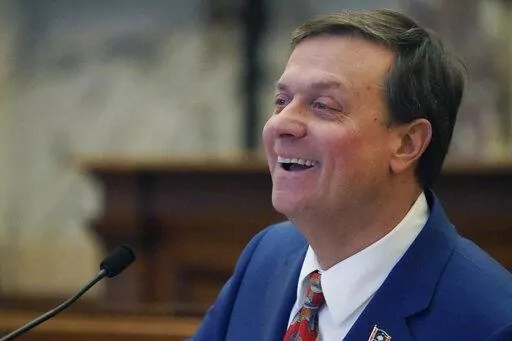 Senate Insurance Committee Chairman Walter Michel, R-Ridgeland, breaks into a smile as he attempts to keep a straight face while answering questions about legislation on establishing provisions for the sale and renewal of pet insurance policies, in the Senate Chamber at the Mississippi Capitol in Jackson, Wednesday, Feb. 1, 2023. As the bill's presenter, Michel took some good natured ribbing from members. (AP Photo/Rogelio V. Solis)