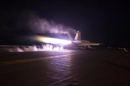 This image provided by the U.S. Navy shows an aircraft launching from USS Dwight D. Eisenhower (CVN 69) during flight operations in the Red Sea, Jan. 22, 2024. The United States and Britain struck 36 Houthi sites in Yemen on Saturday, Feb. 3, in a second wave of assaults meant to further disable Iran-backed groups in the region. (Kaitlin Watt/U.S. Navy via AP)
