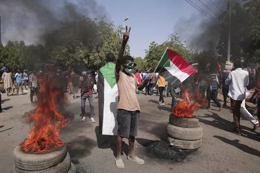 People take part in a protest against the October military takeover and a subsequent deal that reinstated Prime Minister Abdalla Hamdok but sidelined the movement in Khartoum, Sudan, Sunday, Dec. 19, 2021. (AP Photo/Marwan Ali)