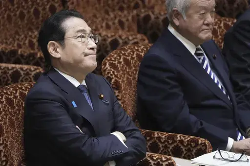 Japanese Prime Minister Fumio Kishida, left, and Finance Minister Shunichi Suzuki, right, attend a parliamentary session of House of Councilors in Tokyo, Monday, March 25, 2024. North Korea said Monday that Prime Minister Kishida has proposed a summit with North Korean leader Kim Jong Un, as the North urged Japan to show sincerity toward improving bilateral ties and realizing their countries’ first summit in about 20 years.(Kyodo News via AP)