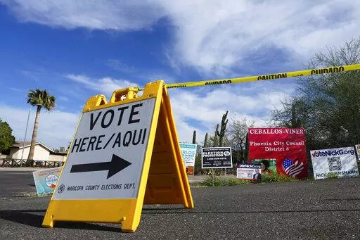 A voting sign points voters in the right direction to drop off ballots in Phoenix, Monday, Nov. 7, 2022. On Friday, Nov. 18, The Associated Press reported on stories circulating online incorrectly claiming the fact that incumbent Republican state treasurer Kimberly Yee got tens of thousands more votes than GOP gubernatorial candidate Kari Lake shows the Arizona election was rigged.  (AP Photo/Ross D. Franklin, File)