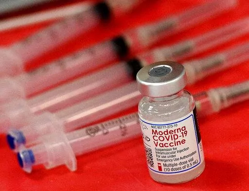 Syringes and a vial of the Moderna COVID-19 vaccine are displayed at a mass COVID-19 vaccination site in Batavia, Ill., on March 19, 2021. Moderna hopes to offer updated COVID-19 boosters in the fall that combine its original vaccine with protection against the omicron variant. On Tuesday, April 19, 2022, it reported a preliminary hint that such an approach might work. (Rick West/Daily Herald via AP, File)