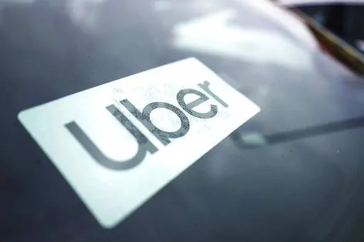 An Uber sign is displayed inside a car in Palatine, Ill., Thursday, Feb. 10, 2022. As Uber pushed into markets around the world, the ride-sharing service lobbied political leaders to relax labor and taxi laws and used a “kill switch″ to thwart regulators and law enforcement. Uber also channeled money through Bermuda and other tax havens and considered portraying violence against its drivers as a way to gain public sympathy. That's according to a report released Sunday by the International Co