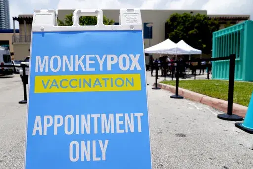  A sign for monkeypox vaccinations is shown at a vaccination site, Wednesday, Aug. 10, 2022, in Miami Beach, Fla. British health officials say the monkeypox outbreak across the country “shows signs of slowing” but that it's still too soon to know if the decline will be maintained. In a statement on Monday, Aug. 15 the Health Security Agency said authorities are reporting about 29 new monkeypox infections every day, compared to about 52 cases a day during the last week in June (AP Photo/Lynne